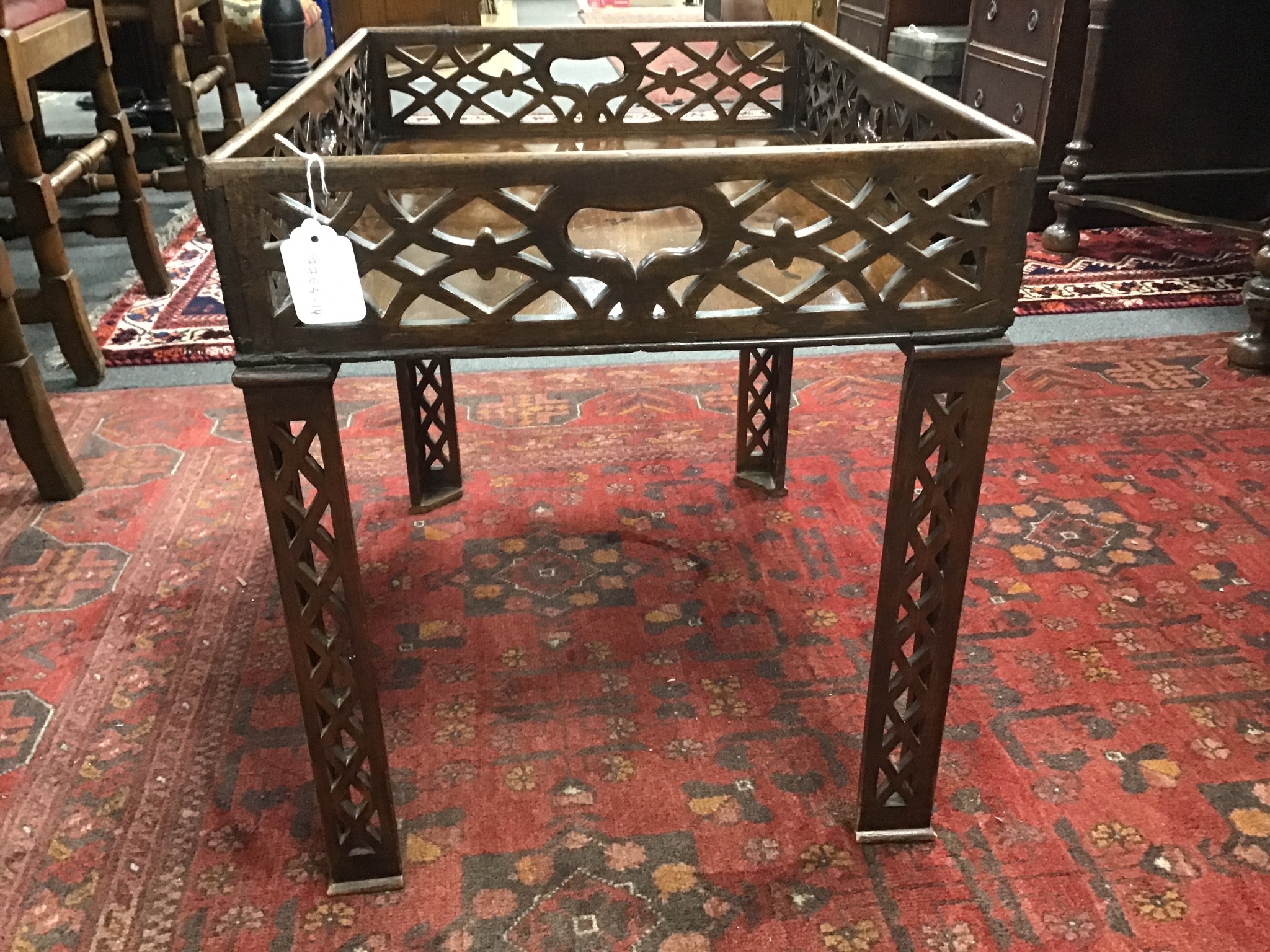 A George III pierced mahogany rectangular tray now as an occasional table on associated legs, width 59cms, depth 43cms, height 50cms.